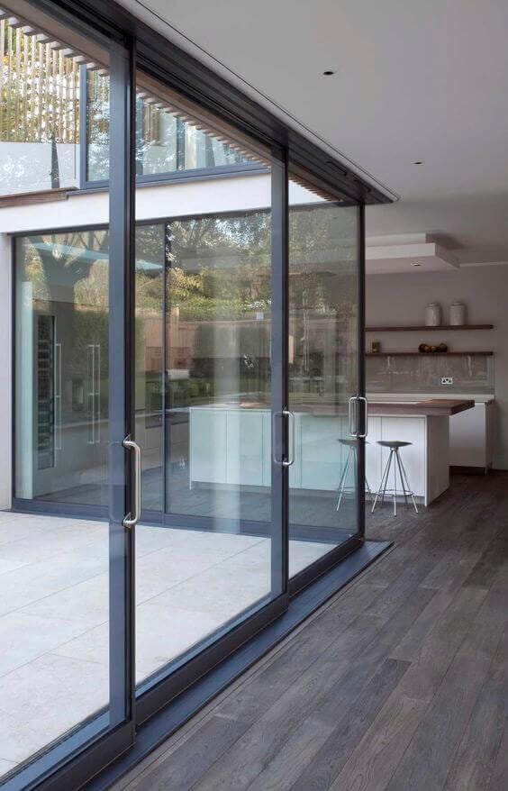 Sleek modern patio door ideas featuring large glass doors that connect indoor and outdoor spaces, enhancing natural light and usability.