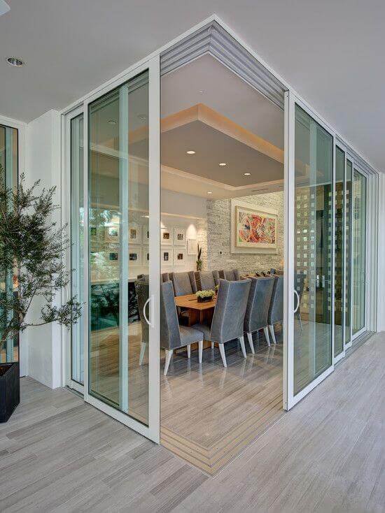 Dining room features large glass sliding doors connecting indoor and outdoor spaces, enhancing openness and natural light.