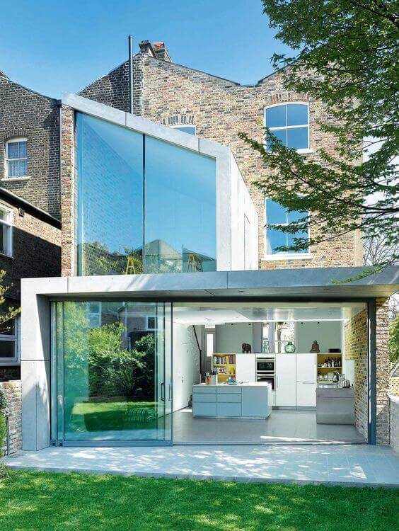 Sleek modern patio featuring large glass sliding doors, blending indoor and outdoor spaces with minimalist design and natural light.