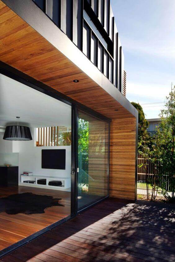Modern patio door ideas feature large glass sliding doors, enhancing indoor-outdoor flow with sleek wooden and metallic accents.