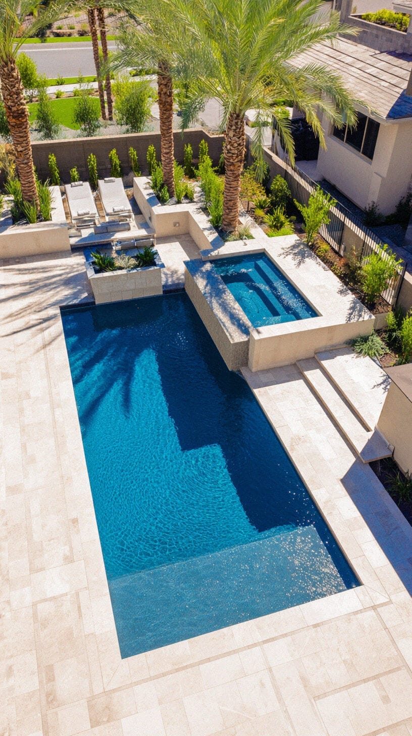 Rectangular swimming pool (20x10 ft) with a depth of 3-5 ft, gunite and pebble finish, surrounded by limestone decking and palm trees.